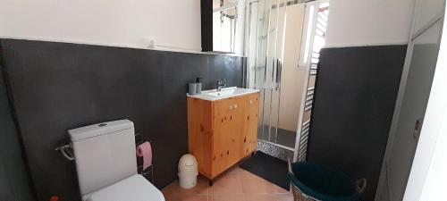 a bathroom with a white toilet and a sink at Haut de villa calme, 2 chambres et vue dégagée - proche calanques in Roquefort-la-Bédoule