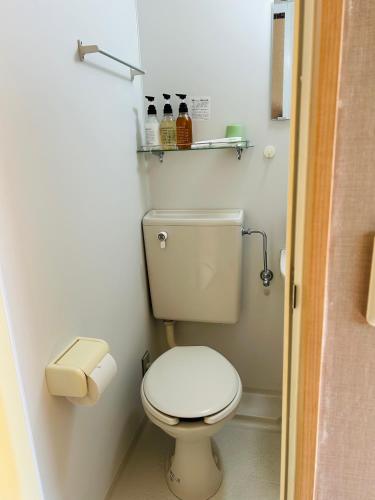 a small bathroom with a white toilet in a room at Izu-no-umi Hotel in Atami