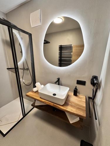 a bathroom with a sink and a mirror at Alpin Studio Haus, Kaibling & Ski amadé in Haus im Ennstal