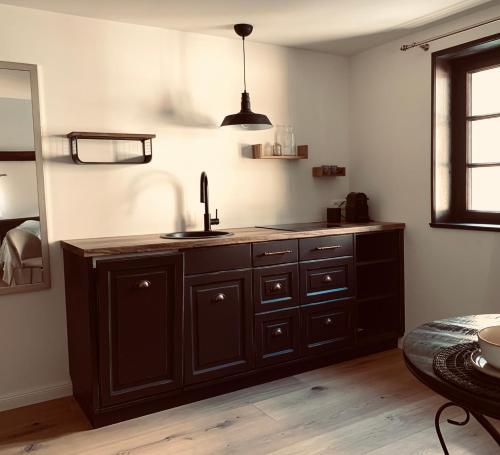 a kitchen with a sink and a counter top at undfein boutique studios in Sankt Gilgen