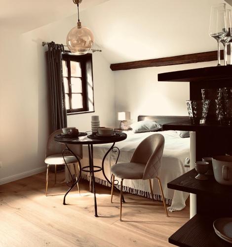 a bedroom with a bed and a table and chairs at undfein boutique studios in Sankt Gilgen