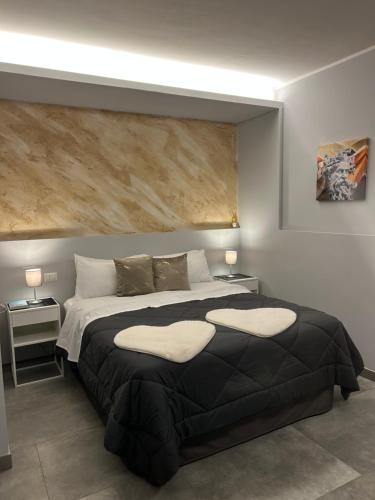 a bedroom with a large bed with two pillows on it at La casa di Sesè in Viagrande