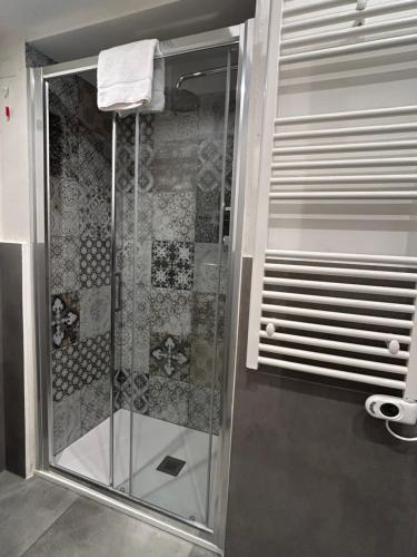 a shower with a glass door in a bathroom at La casa di Sesè in Viagrande