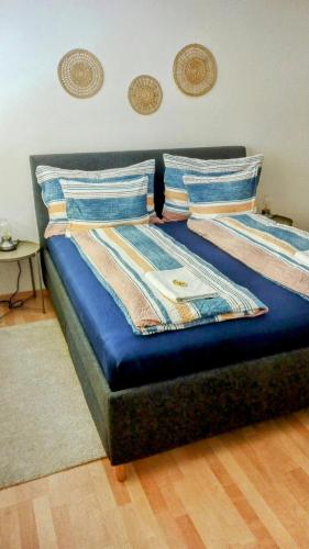 a bed with blue sheets and pillows in a room at Central 2, nice two room apartment, free bus, city tax included in Lucerne