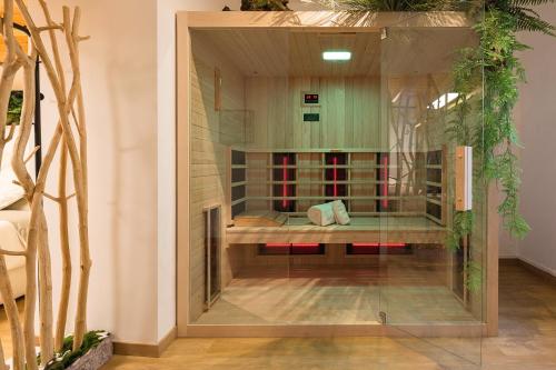 a glass wall in a room with a bed in it at Haven Loft Como - Private Spa, Parking & Jacuzzi in Como