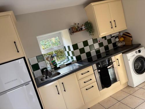 a small kitchen with a sink and a dishwasher at Hidden Hills Waterville - Private Farmhouse in Waterville
