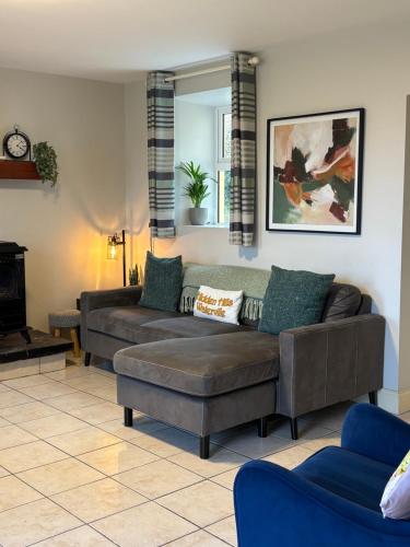 a living room with a couch and a fireplace at Hidden Hills Waterville - Private Farmhouse in Waterville