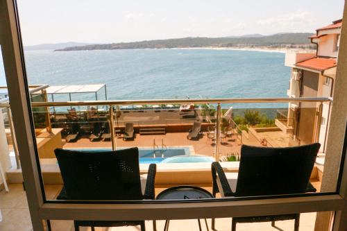 a balcony with chairs and a view of the ocean at Solinaria Boutique Hotel in Sozopol