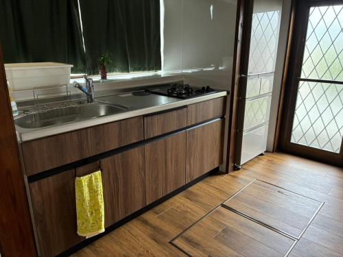 a kitchen with a sink and a counter top at Cottage Tasuki in Nakijin