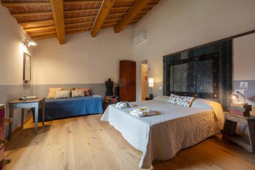 a large room with two beds and a couch at Casa Quadrilumi B&B in Imola