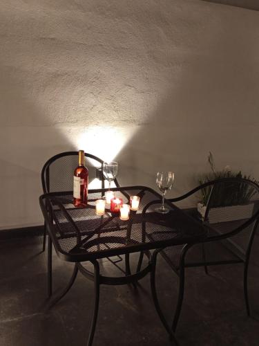 a table with a bottle of wine and candles on it at Hotel Miranda Querétaro in Querétaro