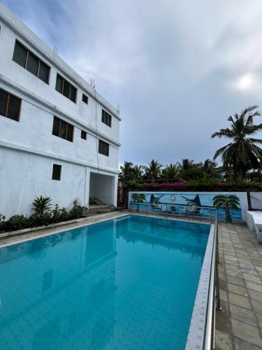 a swimming pool in front of a building at Azure Coast retreat in Watamu