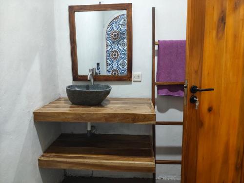 a bathroom with a sink and a mirror at anik homestay & dormy Batukaras in Batukaras