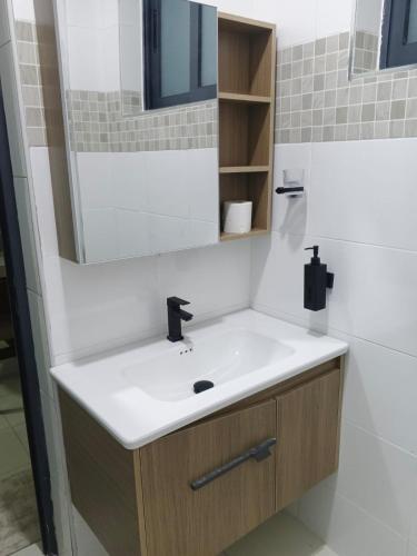 a bathroom with a sink and a mirror at Bluu Diani in Diani Beach