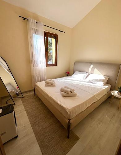 a bedroom with a bed with two towels on it at Villa Piste - Skadar Lake in Virpazar