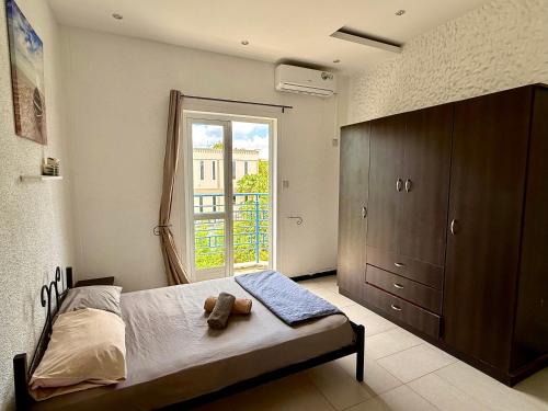 a bedroom with a bed and a large window at Ensuite Room in a shared apartment with pool in Albion