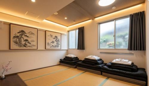 a living room with four couches in a room at 心斎橋難波関空直通Nambaminami direct to Shinsaibashi Ambers Hostel in Osaka