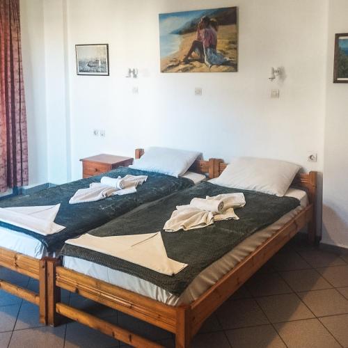 two beds sitting next to each other in a room at Kampos Bliss Studios in Votsalákia