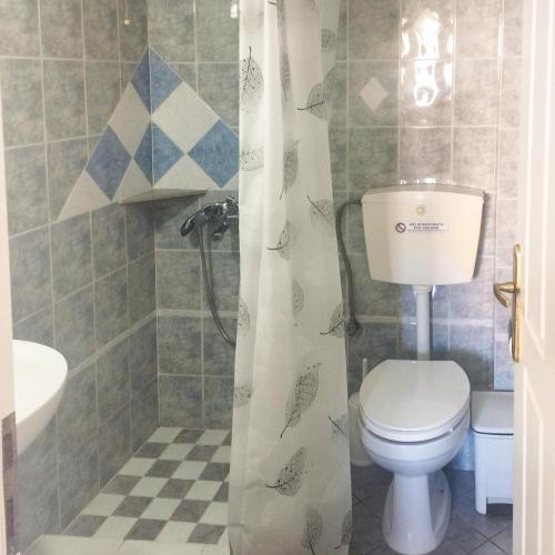 a bathroom with a toilet and a sink at Kampos Bliss Studios in Votsalákia