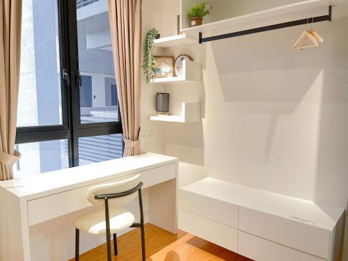 a small white kitchen with a chair and a window at Beacon Executive Suite by NGN - Georgetown Penang in George Town