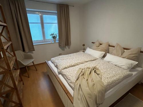 a large bed in a room with a window at Ferienhaus Weidblick in Westerstede