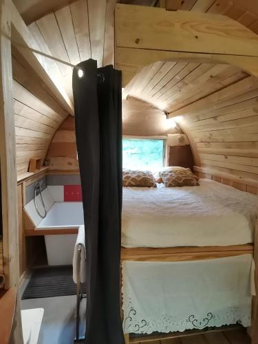 a bedroom in a tiny house at La Verdine in Lacaze