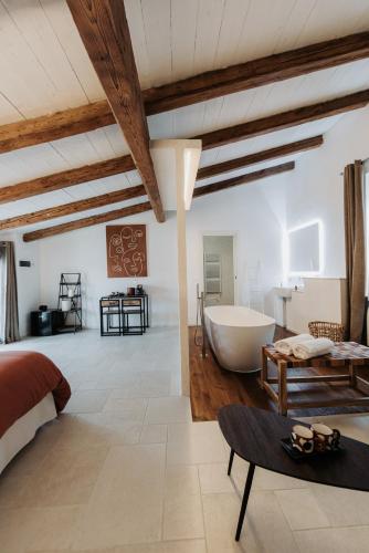 a bedroom with a bed and a tub in a room at Palazzo Mimì in Bitritto