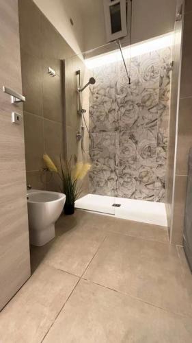 a bathroom with a tub and a toilet and a shower at Civico77AirPort in Naples