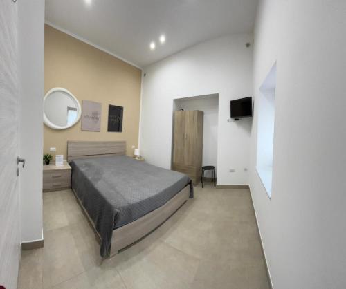 a bedroom with a bed and a sink and a mirror at Civico77AirPort in Naples
