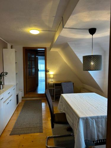 a room with a table and chairs and a kitchen at Haus Anna in Oberdachstetten