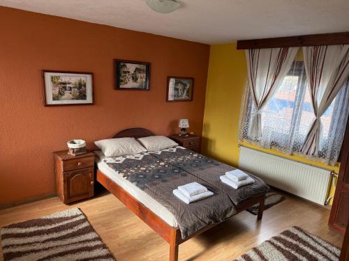a bedroom with a bed with two towels on it at Nenchova Guest House in Koprivshtitsa