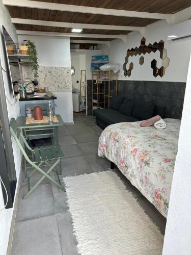a bedroom with a bed and a table and a couch at Buganvilla in Tarifa