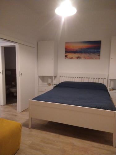 a bedroom with a bed with a blue blanket at Casa nonna Gina in Genoa