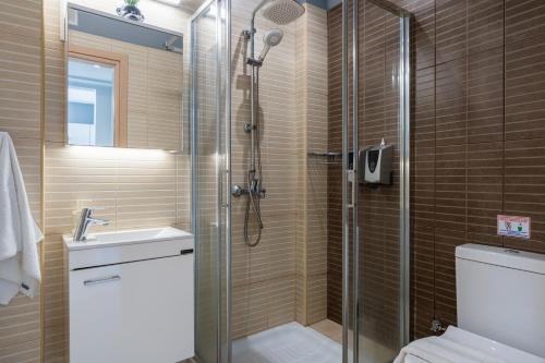 a bathroom with a shower and a toilet and a sink at 1BR Apt. next to Coralli Beach Protaras in Paralimni