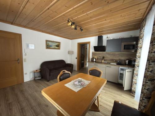 a living room with a table and a kitchen at Haus Monica in Bodenmais
