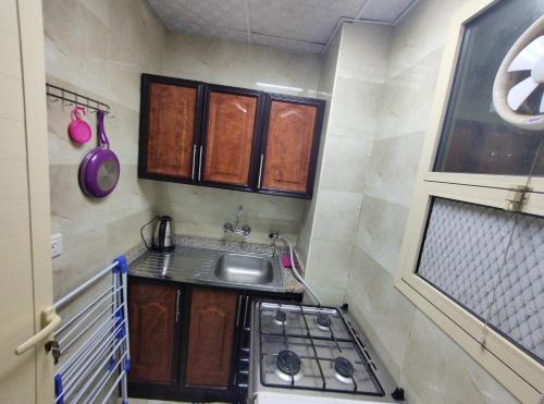 a small kitchen with a sink and a stove at comfort stay 1 in Al Ain