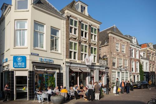 a group of people sitting at tables in a street at Logement De Kleine Gans in Utrecht