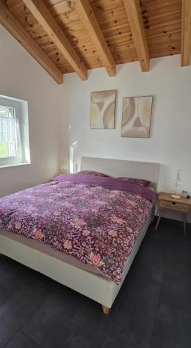 a bedroom with a bed with a purple comforter at Appartement Lens in Lens