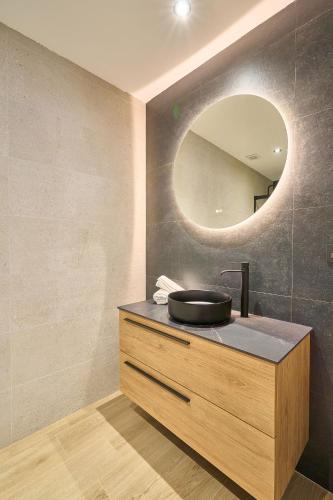 a bathroom with a sink and a mirror on a counter at Rosario 32 by keyhom in Salamanca