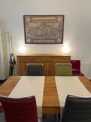 a classroom with two tables and chairs and a map on the wall at Il TRE del TRENTA in Turin