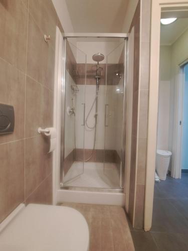 a bathroom with a shower with a glass door at Il TRE del TRENTA in Turin