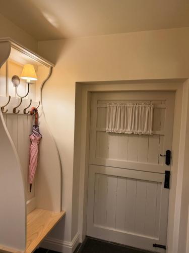 a room with a garage door with a window at Juniper Cottage in Bakewell