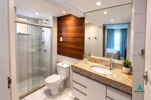 a bathroom with a toilet and a shower and a sink at Palm Beach 206 BL 4 by Holiday Stays in Aquiraz