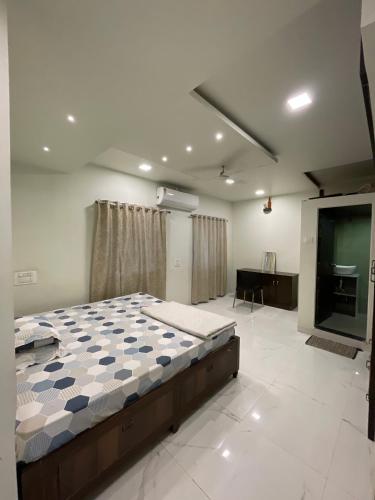 a bedroom with a bed and a flat screen tv at Myra Villa Kolhapur Entire Private Home in Kolhapur