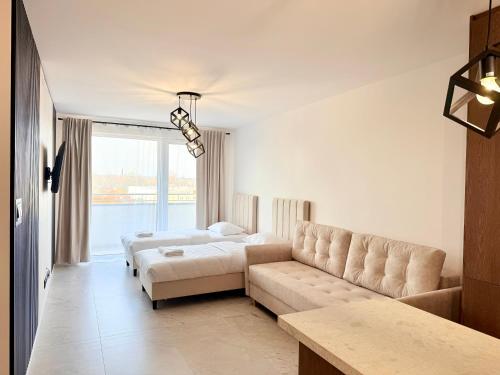 a living room with two beds and a couch at Drahan Apartment 38 in Radom