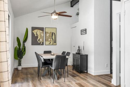a dining room with a table and chairs at The Orange Door - Two Homes - Plunge Pool in Austin