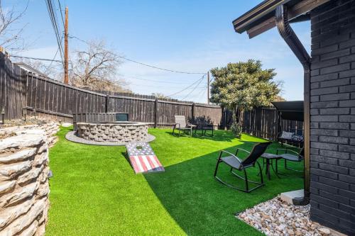 a backyard with a bench and a table and chairs at The Orange Door - Unit A - Heated Plunge Pool in Austin