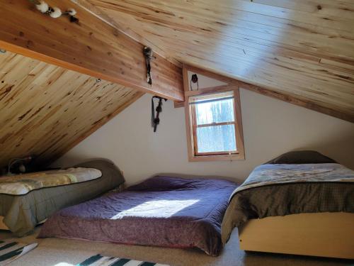 a bedroom with two beds in a attic at BearAss Lodge in Hayward