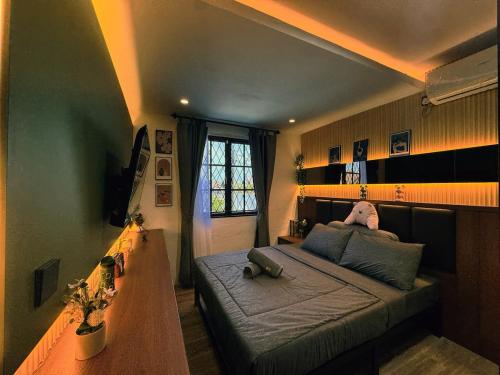 a bedroom with a bed and a table in it at Yokohama Premium House in Batam Center