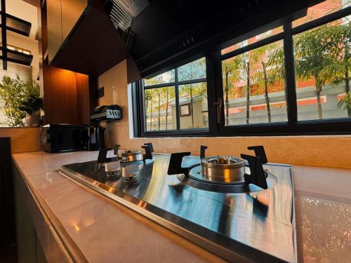 a kitchen counter with two pots and pans on it at Yokohama Premium House in Batam Center